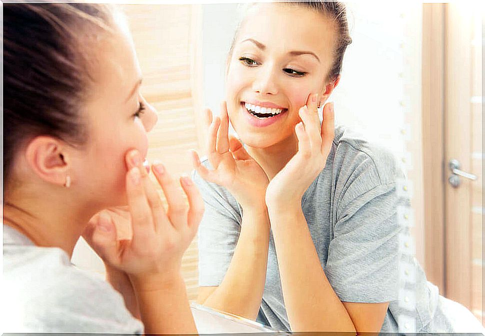 Woman smiling at herself in the mirror