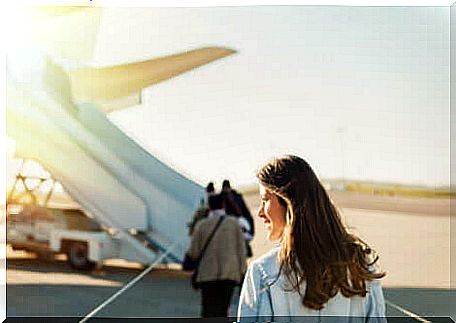 A woman getting ready to board a plane. 