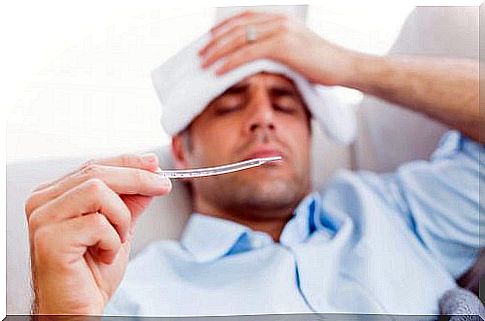 A man with the flu taking his temperature