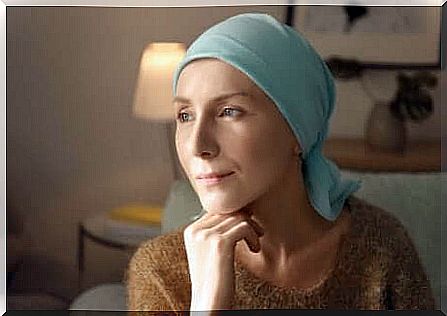 A sick woman with a scarf on her head. 